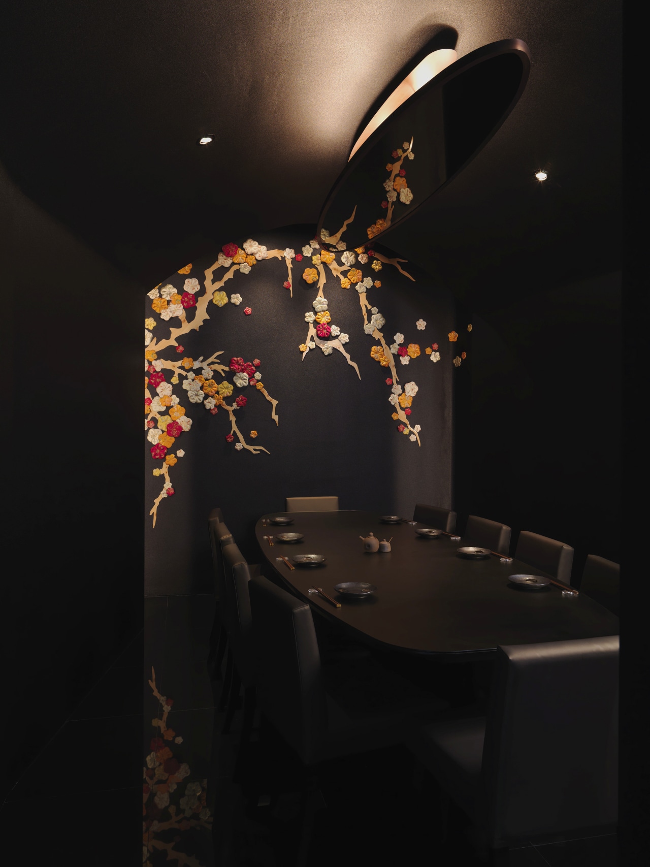 This private dining room has a sake theme, darkness, interior design, light fixture, lighting, still life photography, black