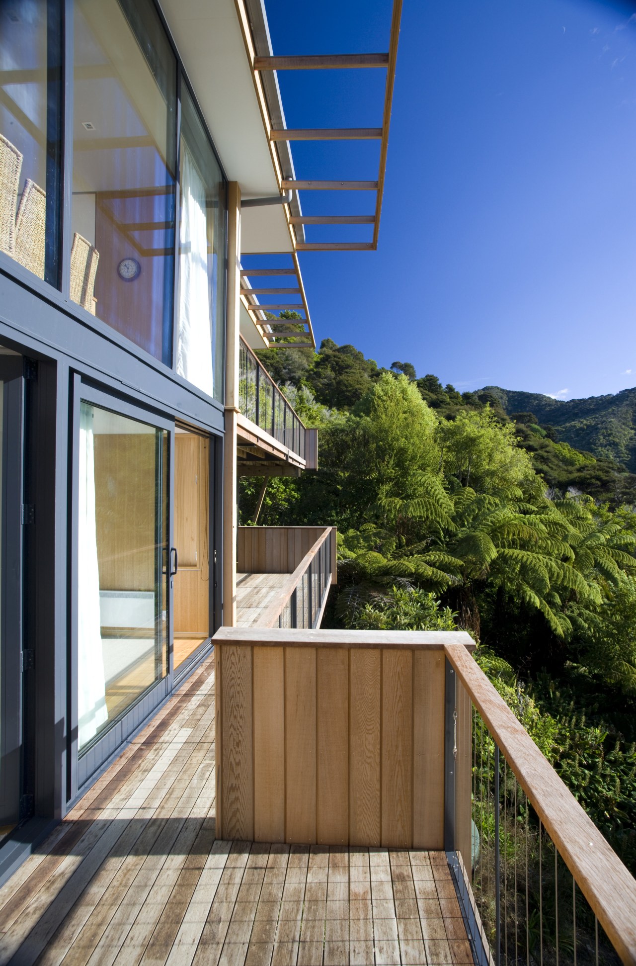 View of deck and side of house with apartment, architecture, balcony, cottage, daylighting, deck, estate, facade, home, house, property, real estate, residential area, roof, window