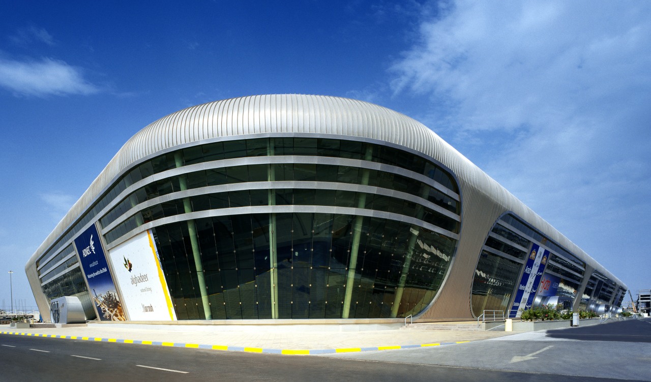 Ovoid forms and futuristic styling define the exhibition architecture, building, commercial building, convention center, corporate headquarters, daytime, facade, headquarters, metropolis, metropolitan area, sky, structure, teal