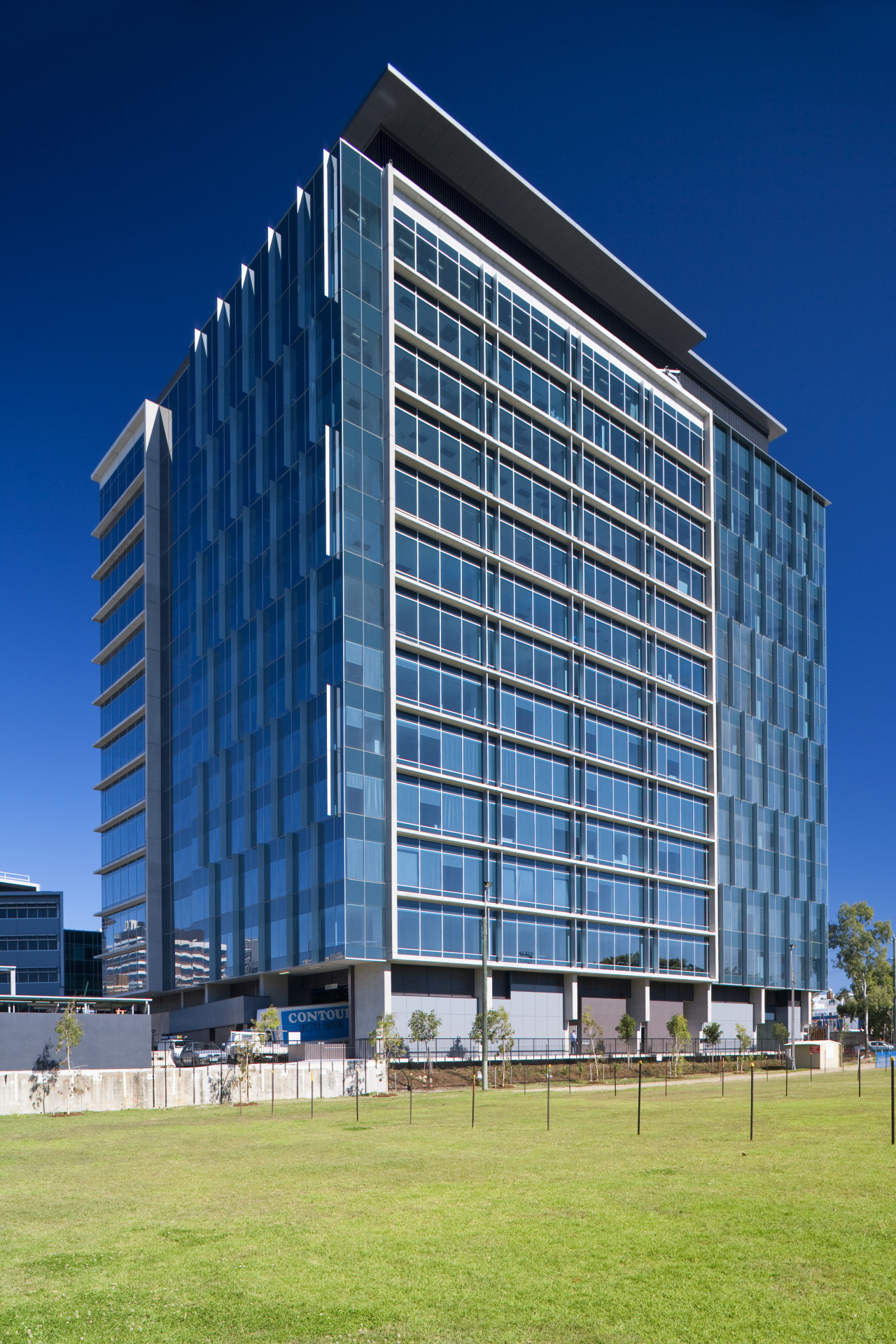 Green Square North Tower cuts a dramatic shape architecture, building, city, commercial building, condominium, corporate headquarters, daytime, facade, headquarters, metropolis, metropolitan area, mixed use, real estate, residential area, sky, skyscraper, tower block, urban area, blue