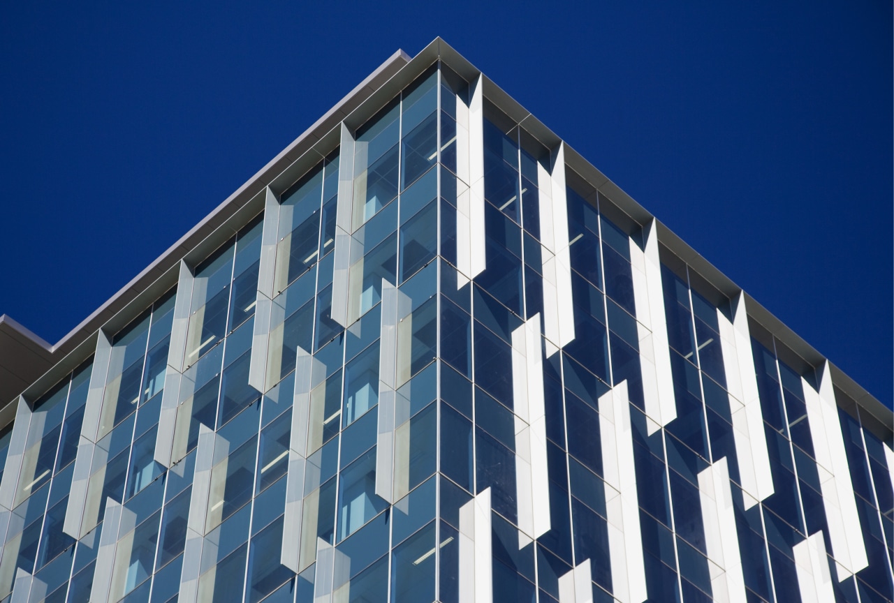 Architectural blades on the window systems combine an architecture, blue, building, commercial building, condominium, corporate headquarters, daylighting, daytime, facade, headquarters, landmark, line, metropolis, metropolitan area, sky, skyscraper, structure, symmetry, tower block, window, blue