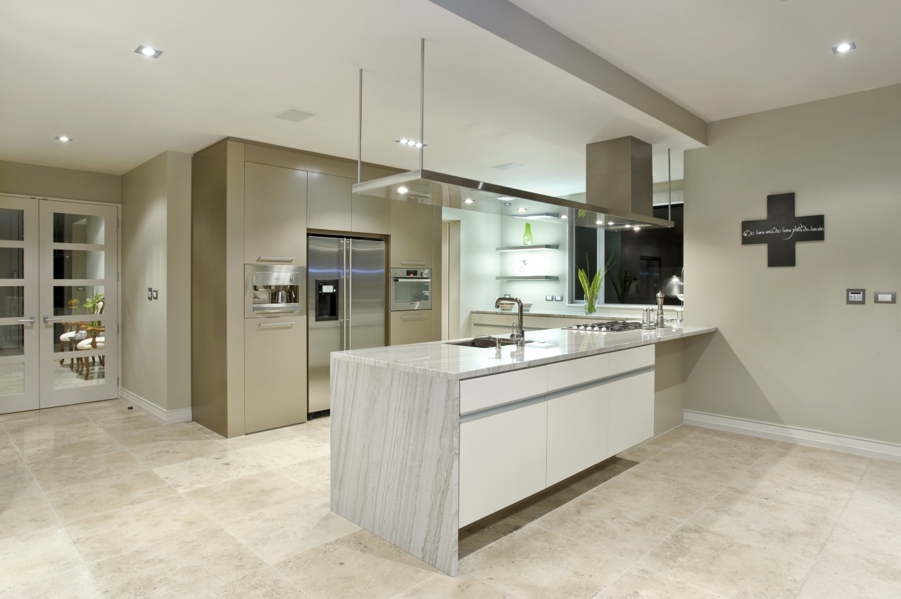 The kitchen, manufactured by Fyfe kitchens, is equipped cabinetry, countertop, floor, flooring, interior design, kitchen, laminate flooring, real estate, room, tile, wood flooring, gray