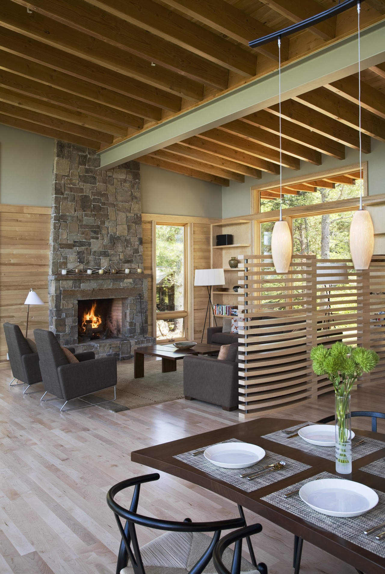 View of the living space in this cabin ceiling, fireplace, flooring, hearth, interior design, living room, lobby, brown, gray