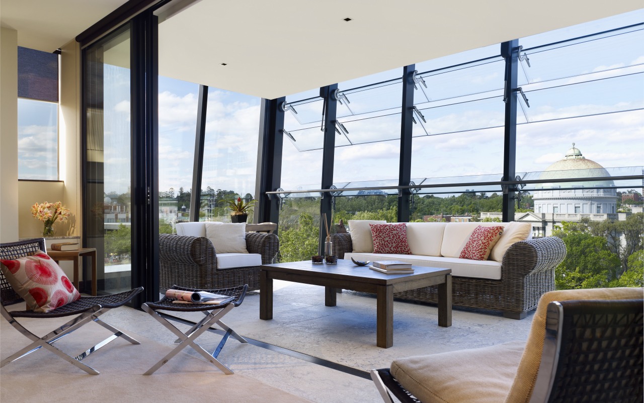 Interior view of the Lucient Apartments which features balcony, daylighting, house, interior design, living room, patio, penthouse apartment, property, real estate, window, gray, white