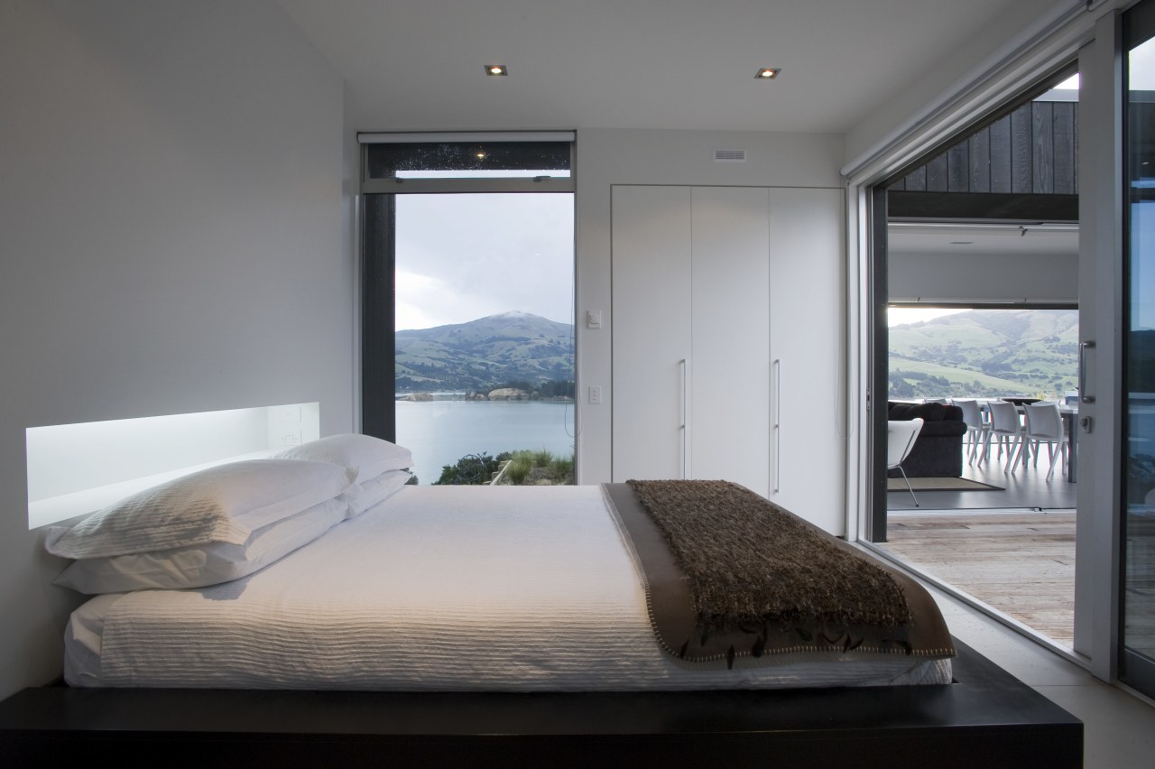 view of bedroom which features glass sliding doors, bedroom, interior design, room, suite, window, gray