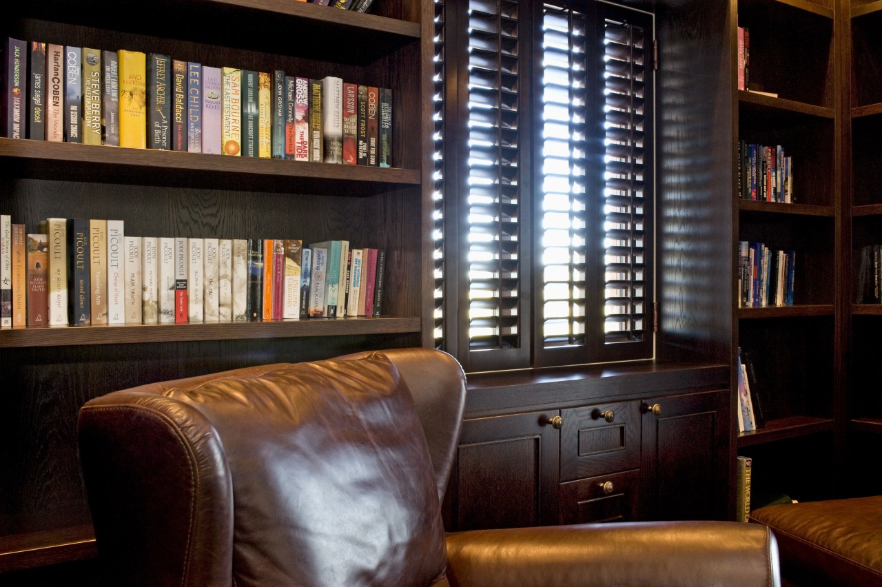 Image of dark stained library shelving and cabinetry bookcase, furniture, interior design, library, shelving, window, black