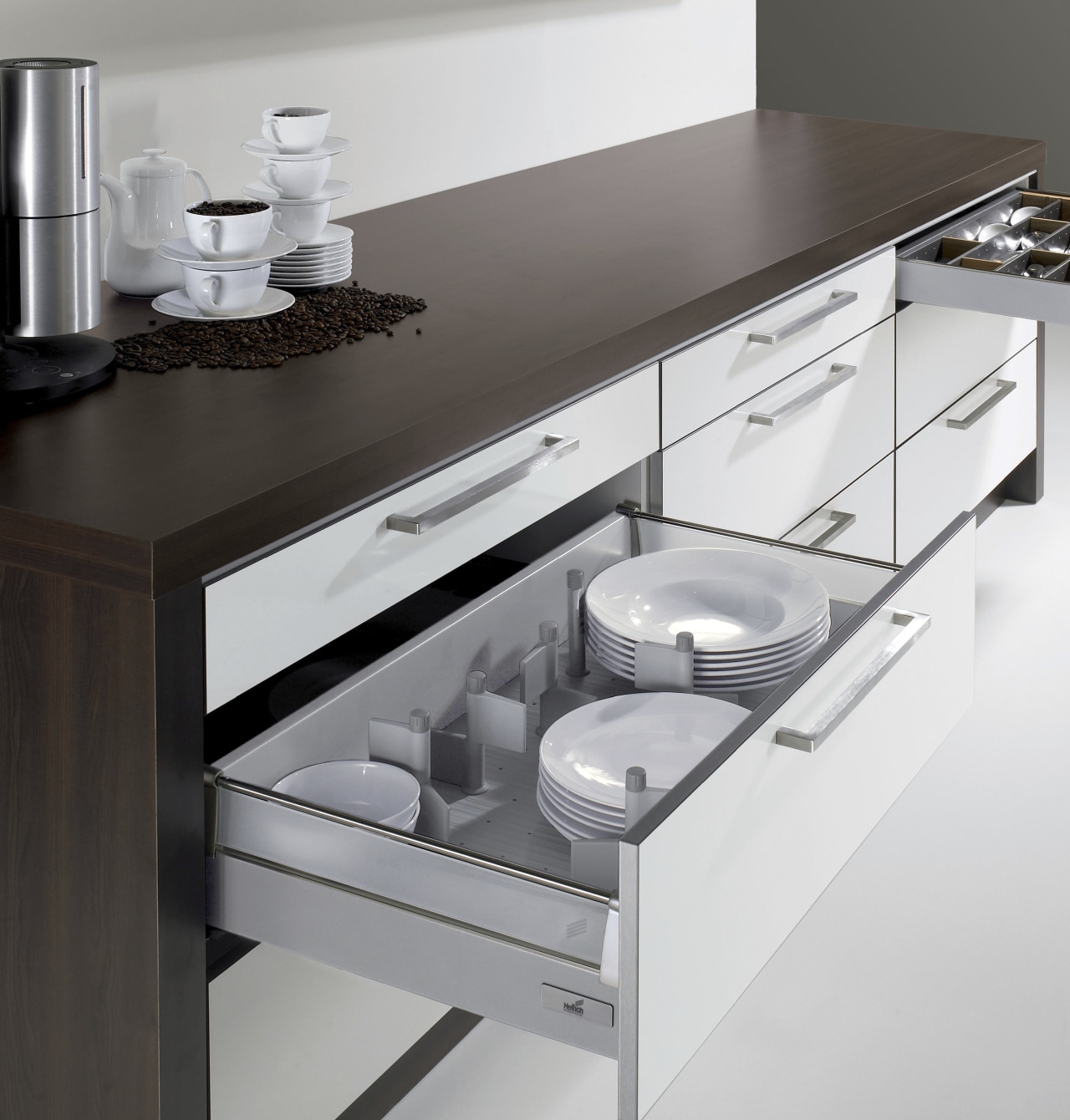 View of kitchen cabinetry with Hettich hardware and countertop, drawer, furniture, home appliance, kitchen, kitchen appliance, kitchen stove, product design, white, gray