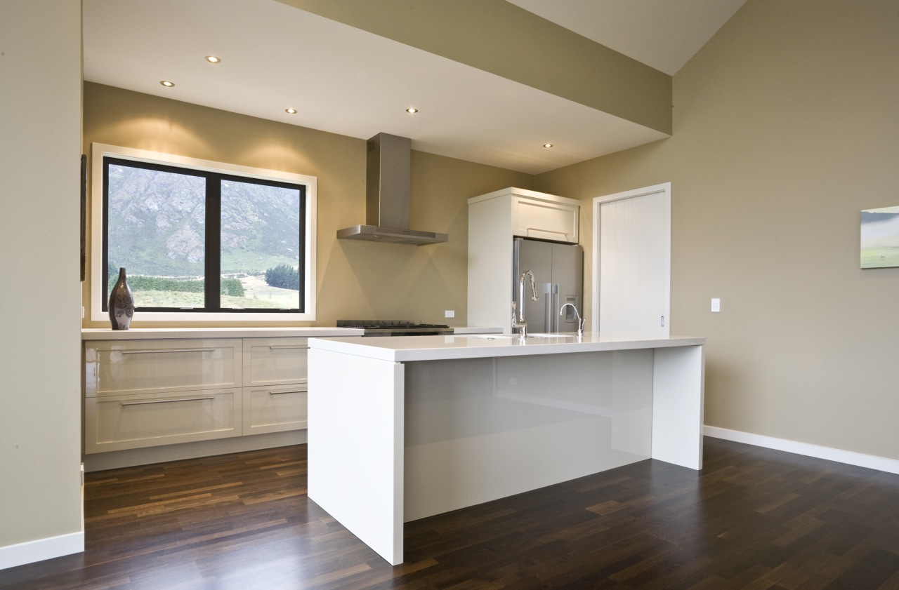 view of a show home kitchen where the cabinetry, ceiling, countertop, floor, flooring, hardwood, home, interior design, kitchen, laminate flooring, property, real estate, room, wood flooring, gray, brown