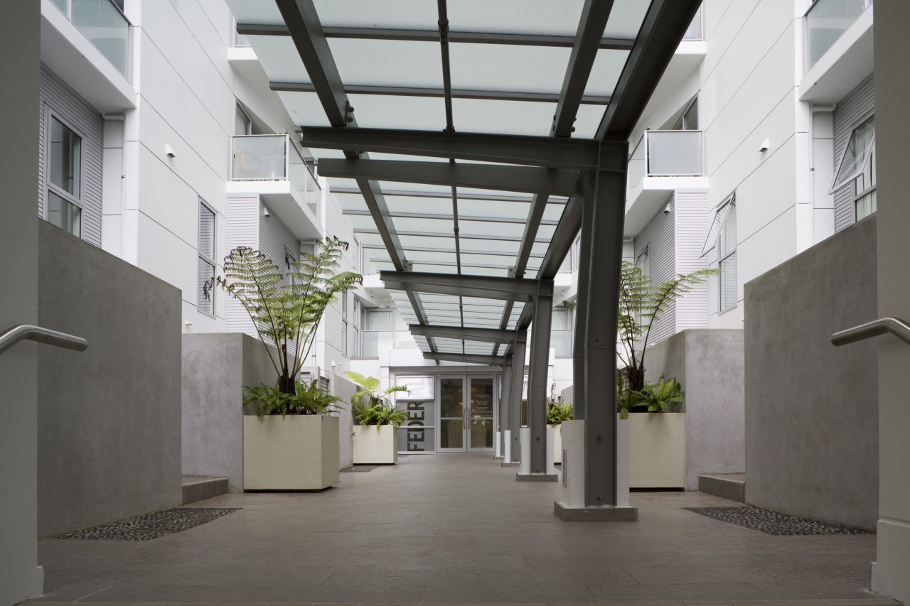 View of a two-storey maisonette which lines the building, condominium, courtyard, daylighting, lobby, gray