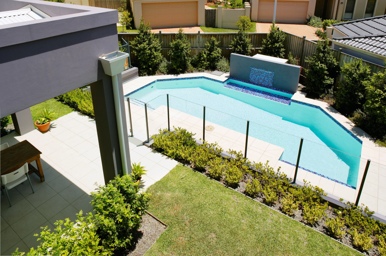 View of the swimming pool and outdoor area backyard, garden, grass, house, leisure, plant, property, real estate, residential area, roof, swimming pool, yard, brown