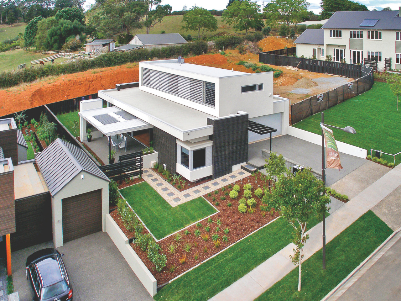 An exterior view of concrete cladding from Celcrete. elevation, home, house, neighbourhood, property, real estate, residential area, roof, suburb, white