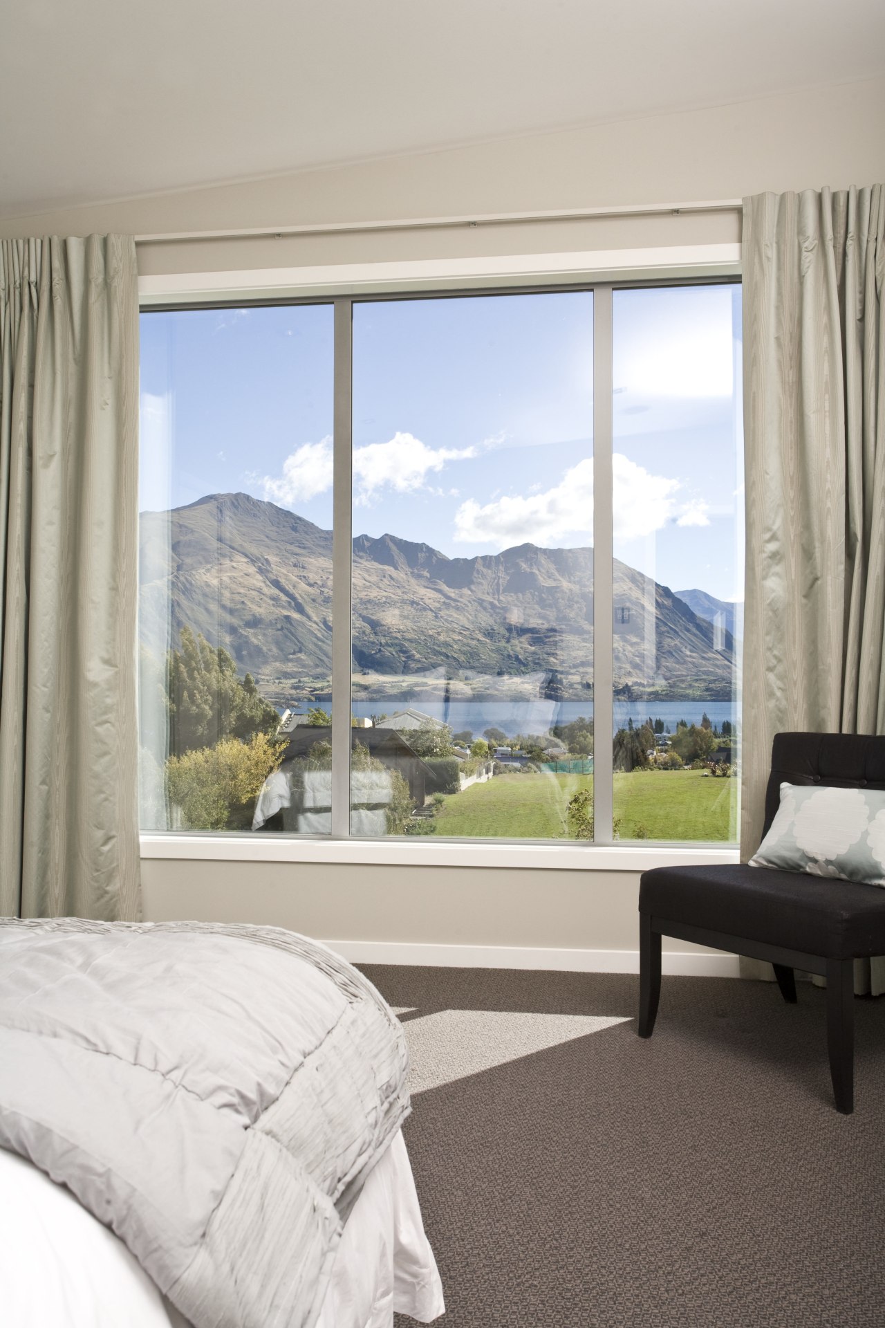 View of the master bedroom inside a home bed frame, bedroom, curtain, daylighting, door, estate, home, house, interior design, living room, property, real estate, room, sash window, shade, window, window covering, window treatment, wood, gray