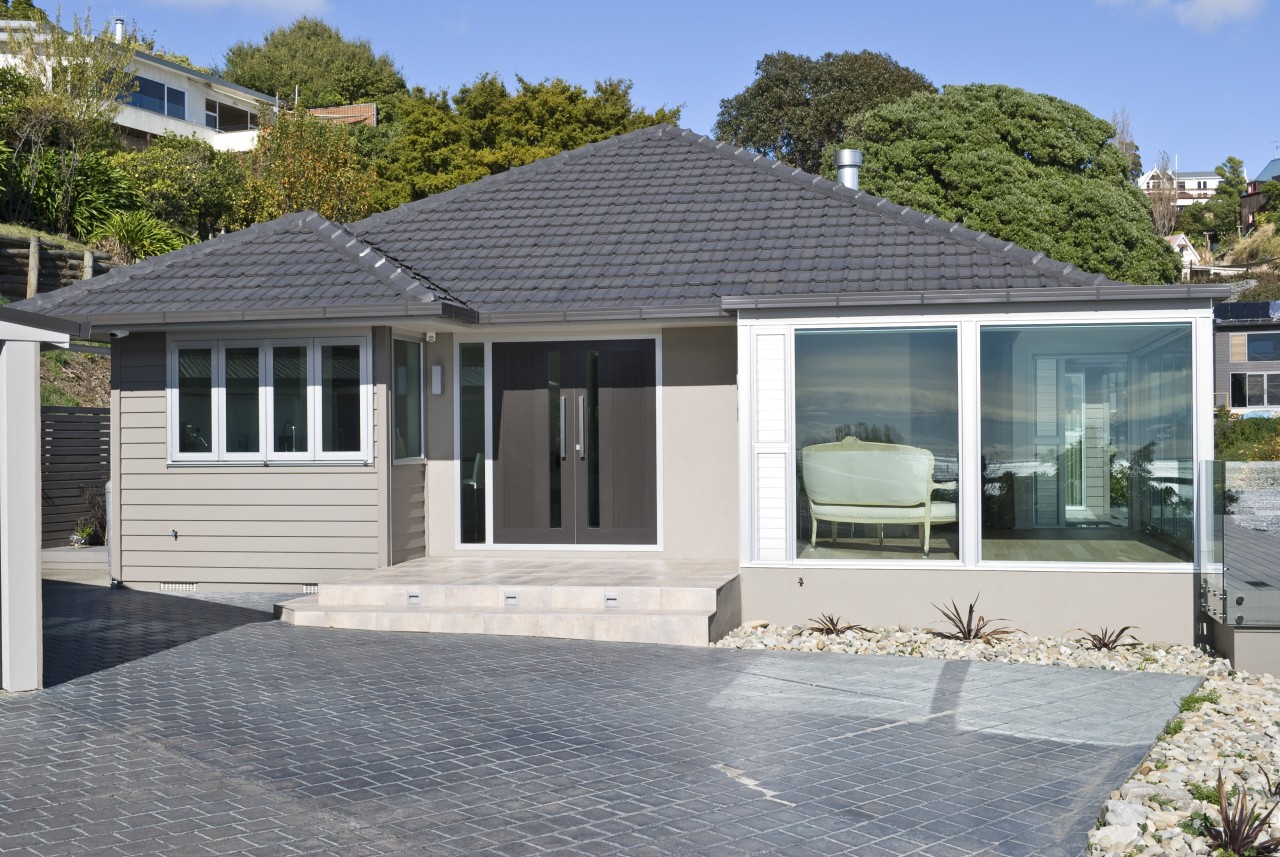 Exterior view of a renovated house which was cottage, elevation, estate, facade, home, house, property, real estate, residential area, siding, window, gray