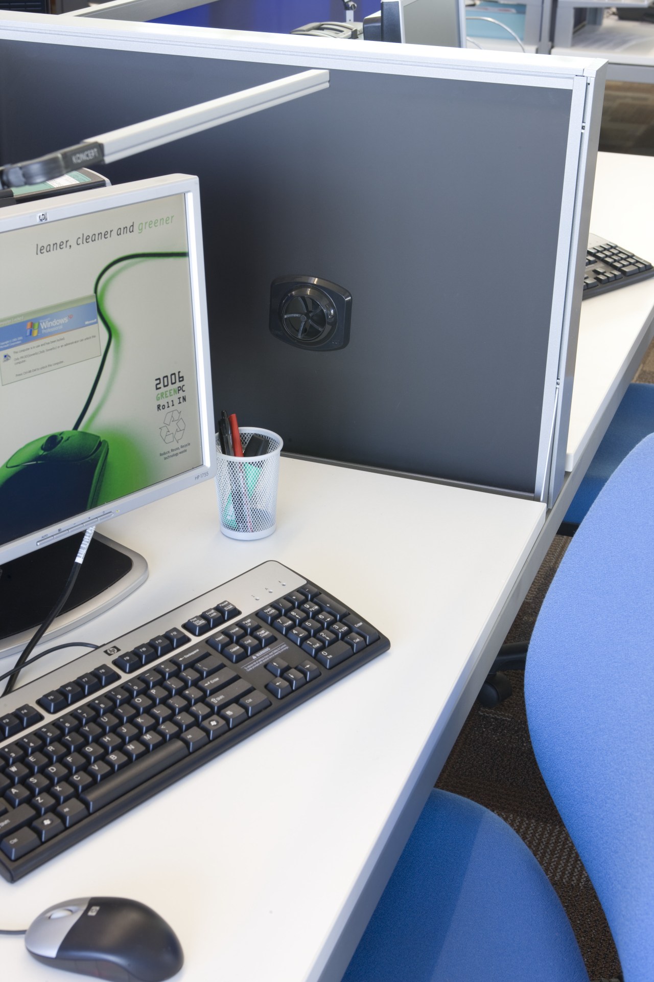 View of an office work station which features desk, desktop computer, electronic device, furniture, laptop, office, personal computer, product design, technology, white