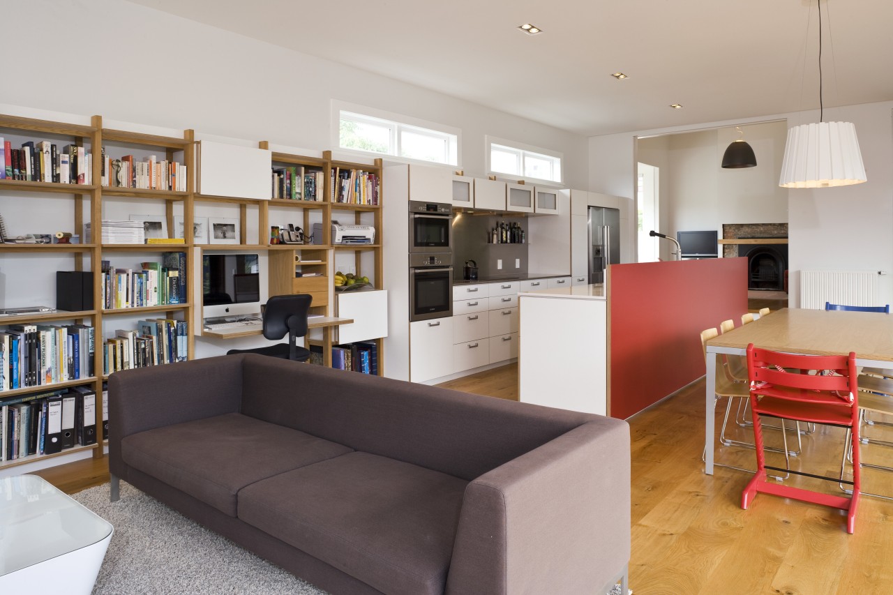 View of open-plan kitchen area which features an bookcase, furniture, institution, interior design, library, living room, real estate, room, shelving, gray