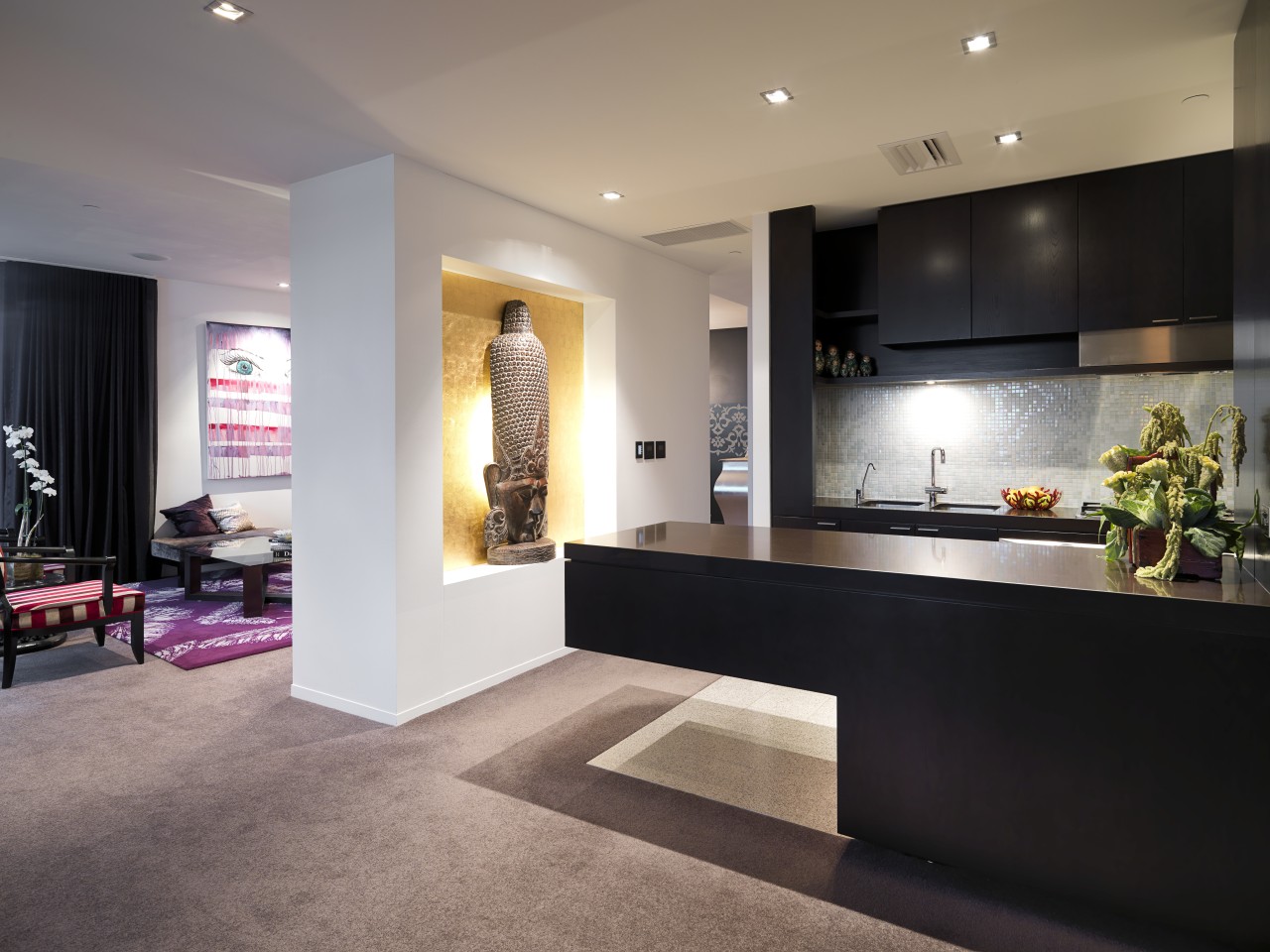 View of the kitchen where the island extends countertop, floor, flooring, interior design, kitchen, living room, lobby, room, gray, black