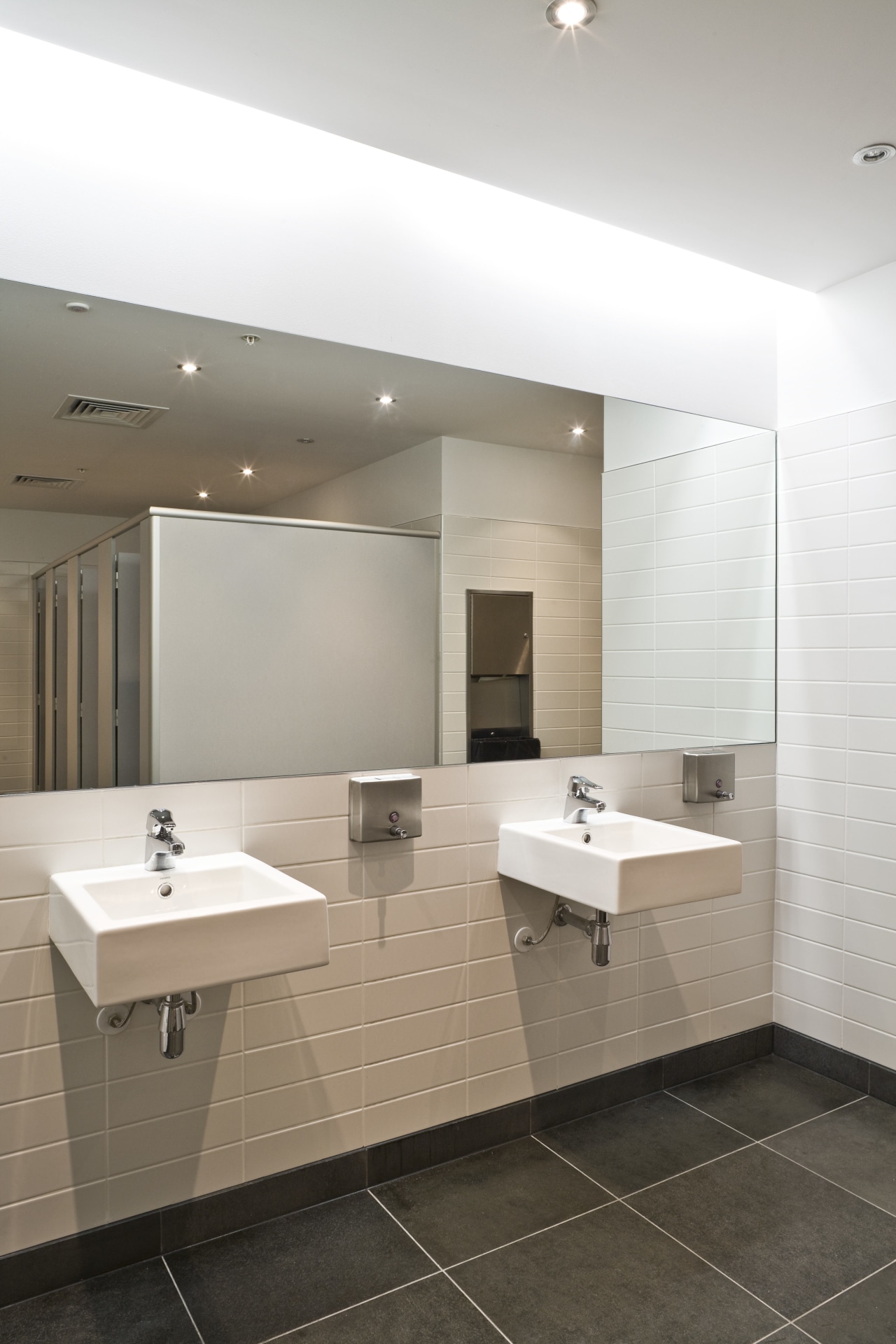 View of a bathroom in the main commercial architecture, bathroom, ceiling, daylighting, floor, flooring, interior design, plumbing fixture, product design, room, sink, tile, wall, white