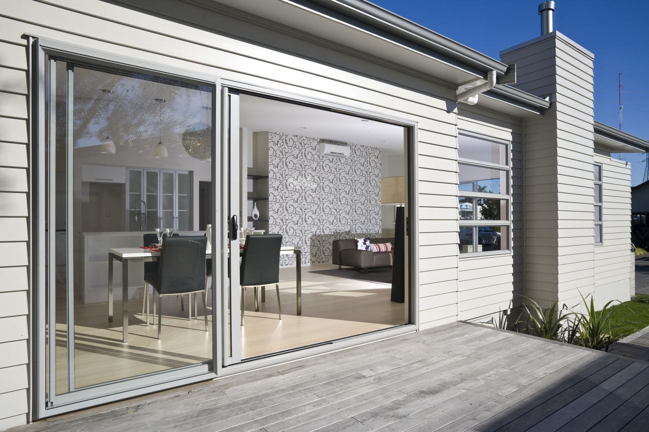 Exterior view of the rear side of this door, facade, house, real estate, siding, window, white, gray