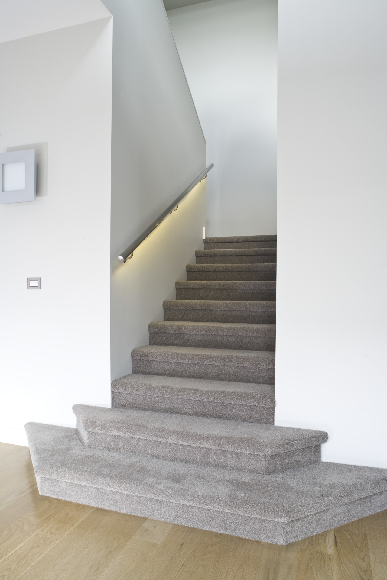 View of a carpeted stairway at the Harbourcity architecture, daylighting, floor, flooring, handrail, home, house, interior design, laminate flooring, product design, stairs, wood flooring, white, gray