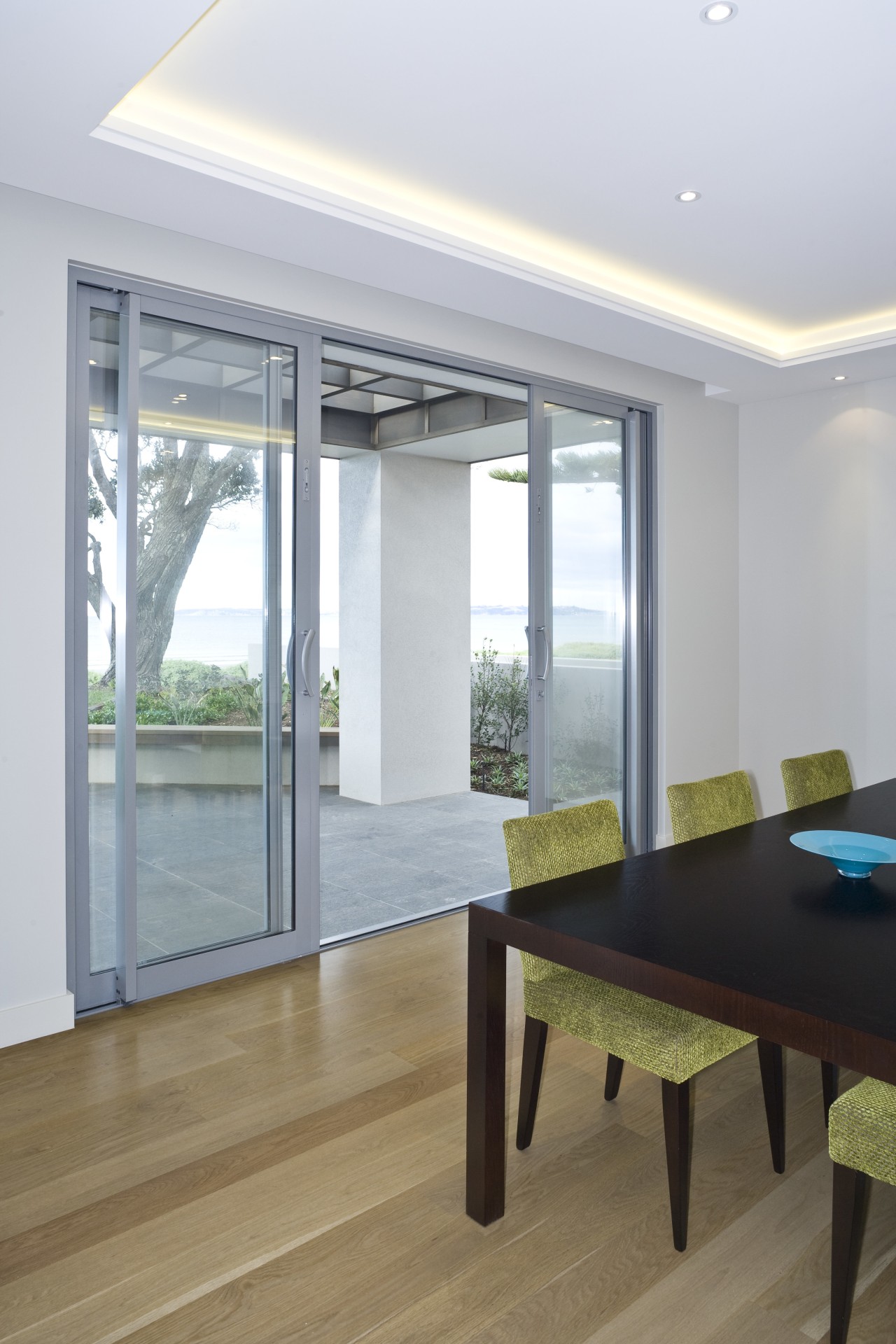 View of the dining area at the Harbourcity architecture, ceiling, daylighting, door, floor, flooring, hardwood, house, interior design, real estate, table, window, wood, wood flooring, gray