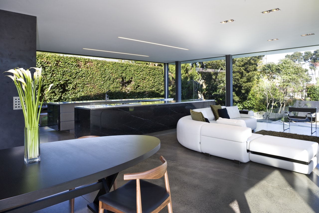 View of open-plan kitchen and living area featuring architecture, home, house, interior design, living room, property, real estate, gray, black