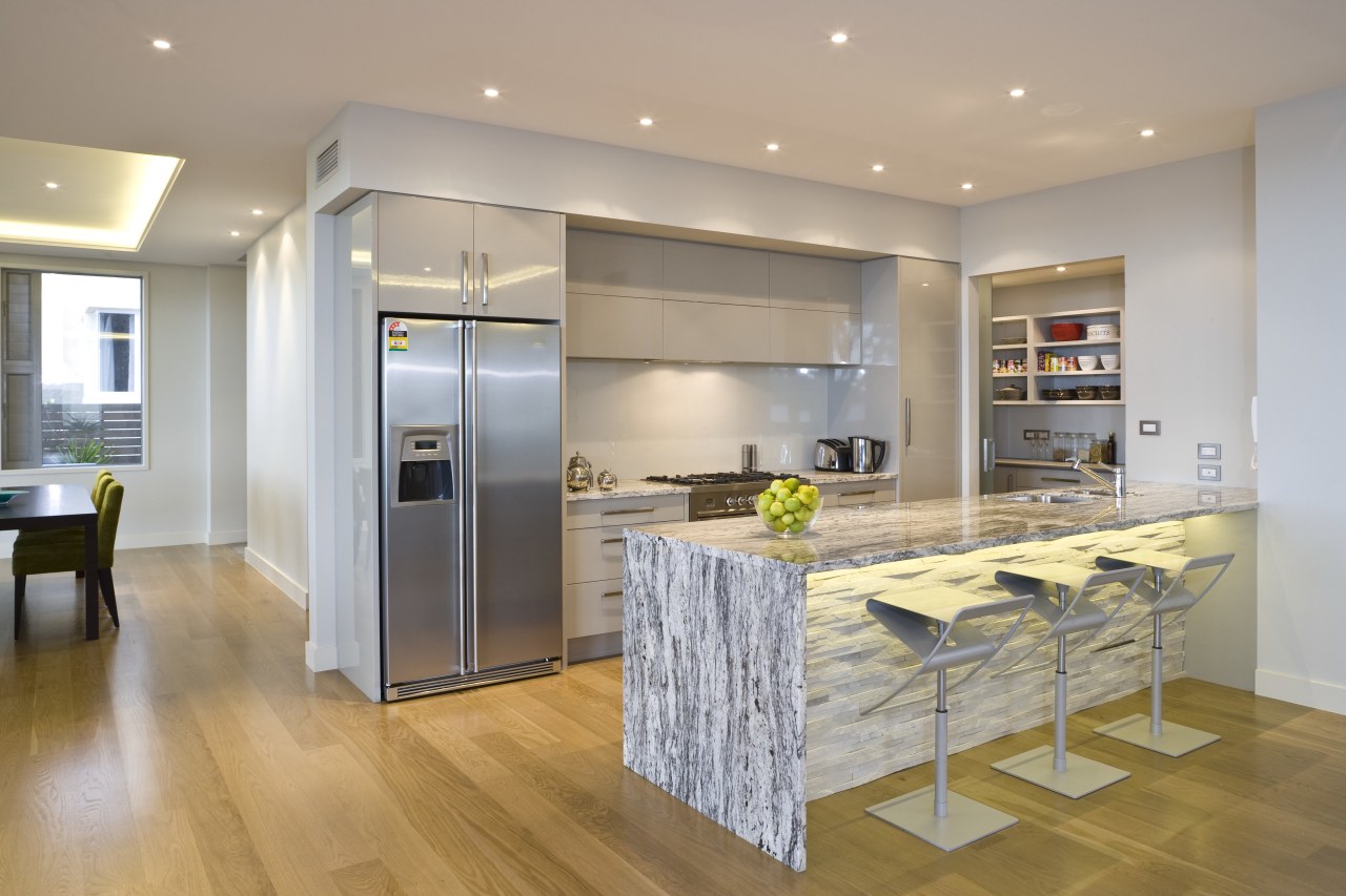 View of the kitchen at the Harbourcity developed cabinetry, countertop, floor, flooring, hardwood, interior design, kitchen, laminate flooring, real estate, room, wood flooring, gray