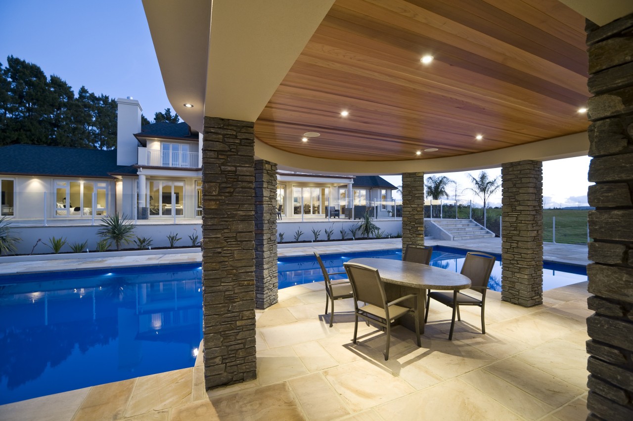 Exterior view of a pavilion which features schist apartment, estate, home, house, interior design, lighting, patio, property, real estate, resort, swimming pool, brown