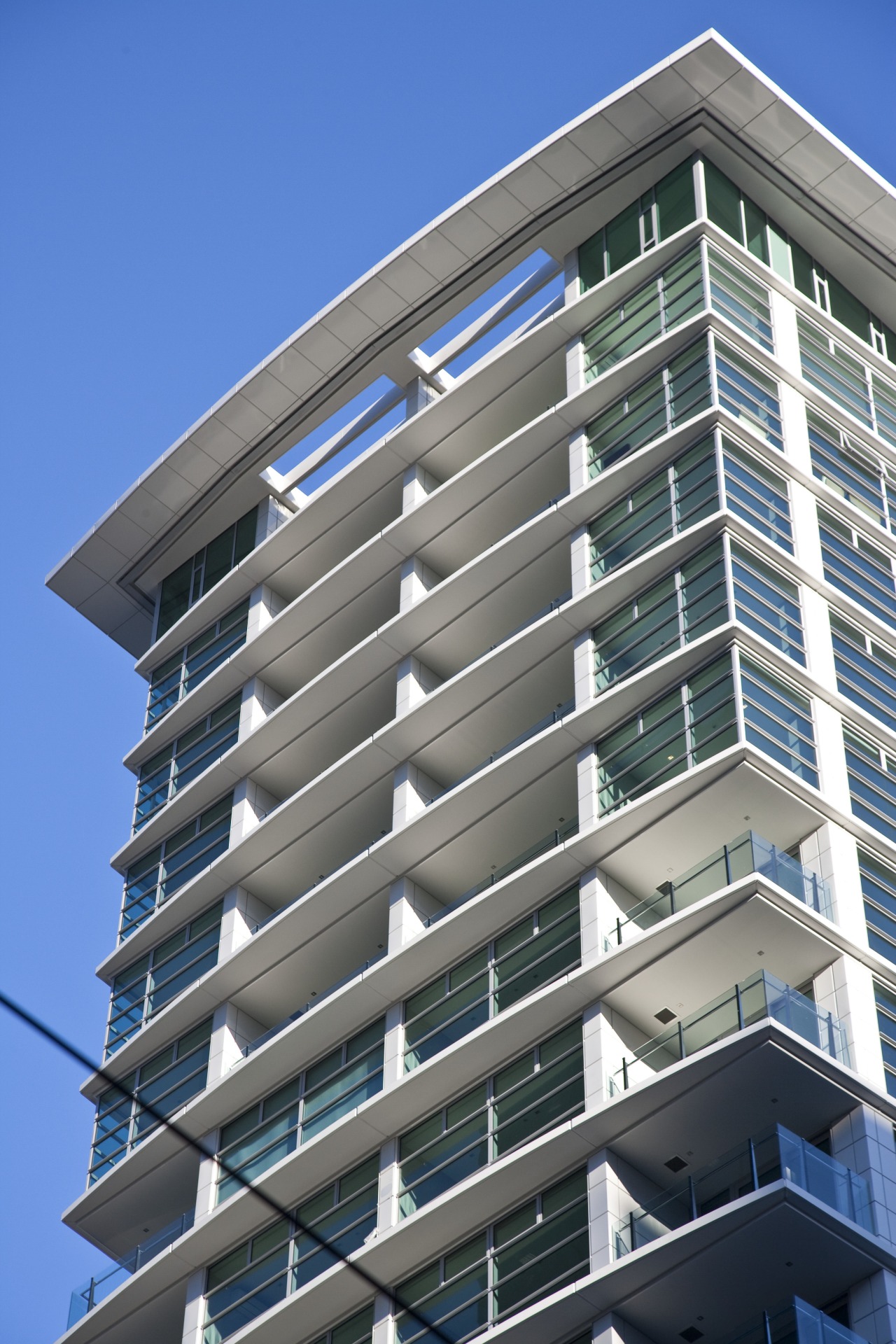 external view of apartment tower above a landscaped apartment, architecture, building, commercial building, condominium, corporate headquarters, daylighting, daytime, elevation, facade, headquarters, house, line, metropolitan area, mixed use, property, real estate, residential area, sky, tower block, urban area, window, gray, blue