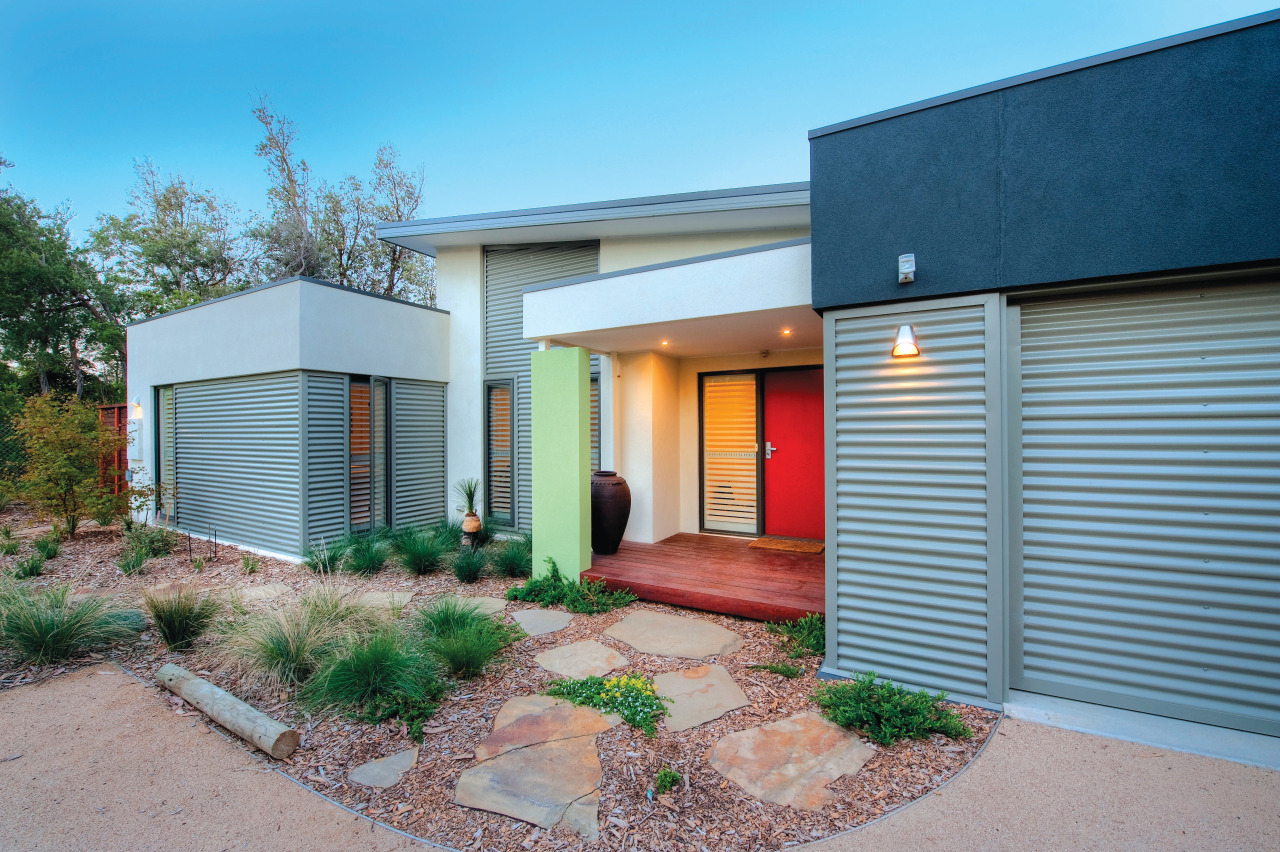 Exterior view of an energy-efficient home designed by elevation, estate, facade, home, house, property, real estate, residential area, siding, gray, teal