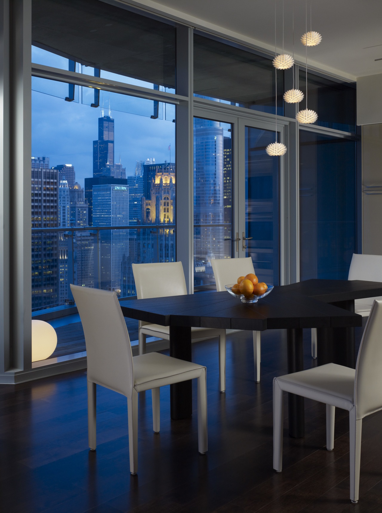 View of the Chicago skyline from the condominium. apartment, architecture, chair, dining room, furniture, interior design, table, window, black, blue