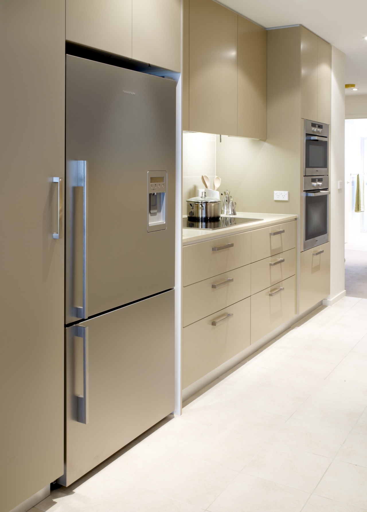 View of the kitchen of a unit at cabinetry, home appliance, interior design, kitchen, major appliance, refrigerator, white, brown