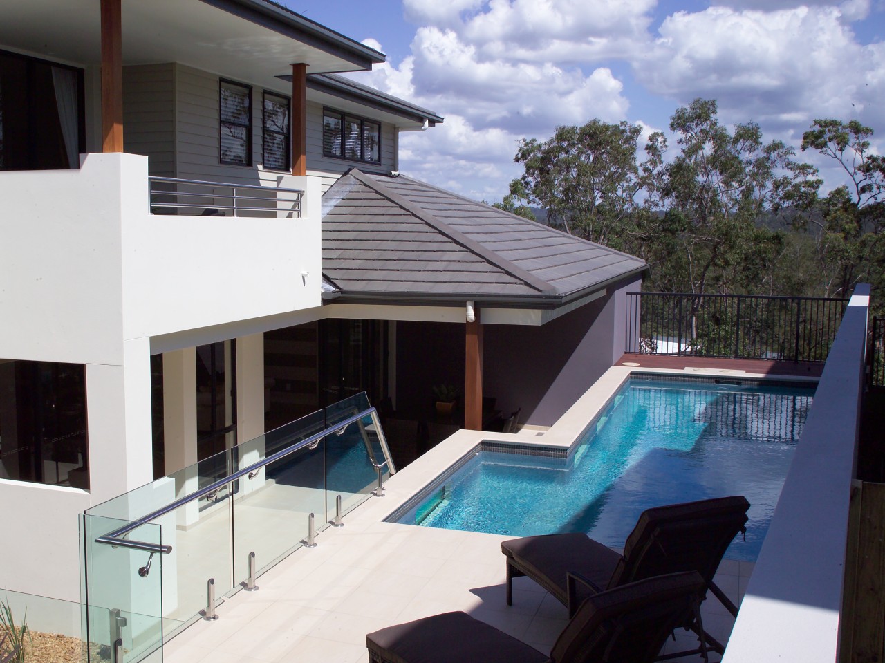 Exterior pool view of the Augusta home. Built estate, home, house, property, real estate, roof, swimming pool, villa, window, white, black