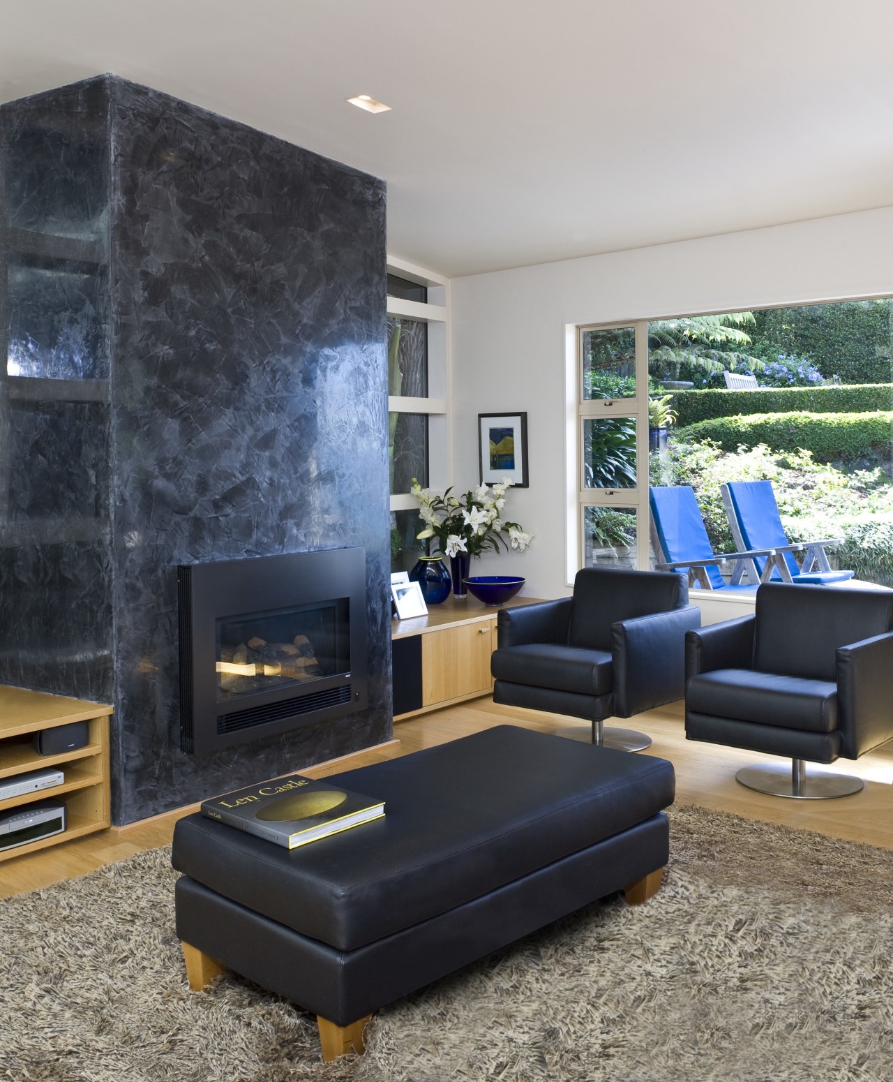 This is a lounge with the fire place couch, furniture, home, interior design, living room, room, table, wall, gray, black