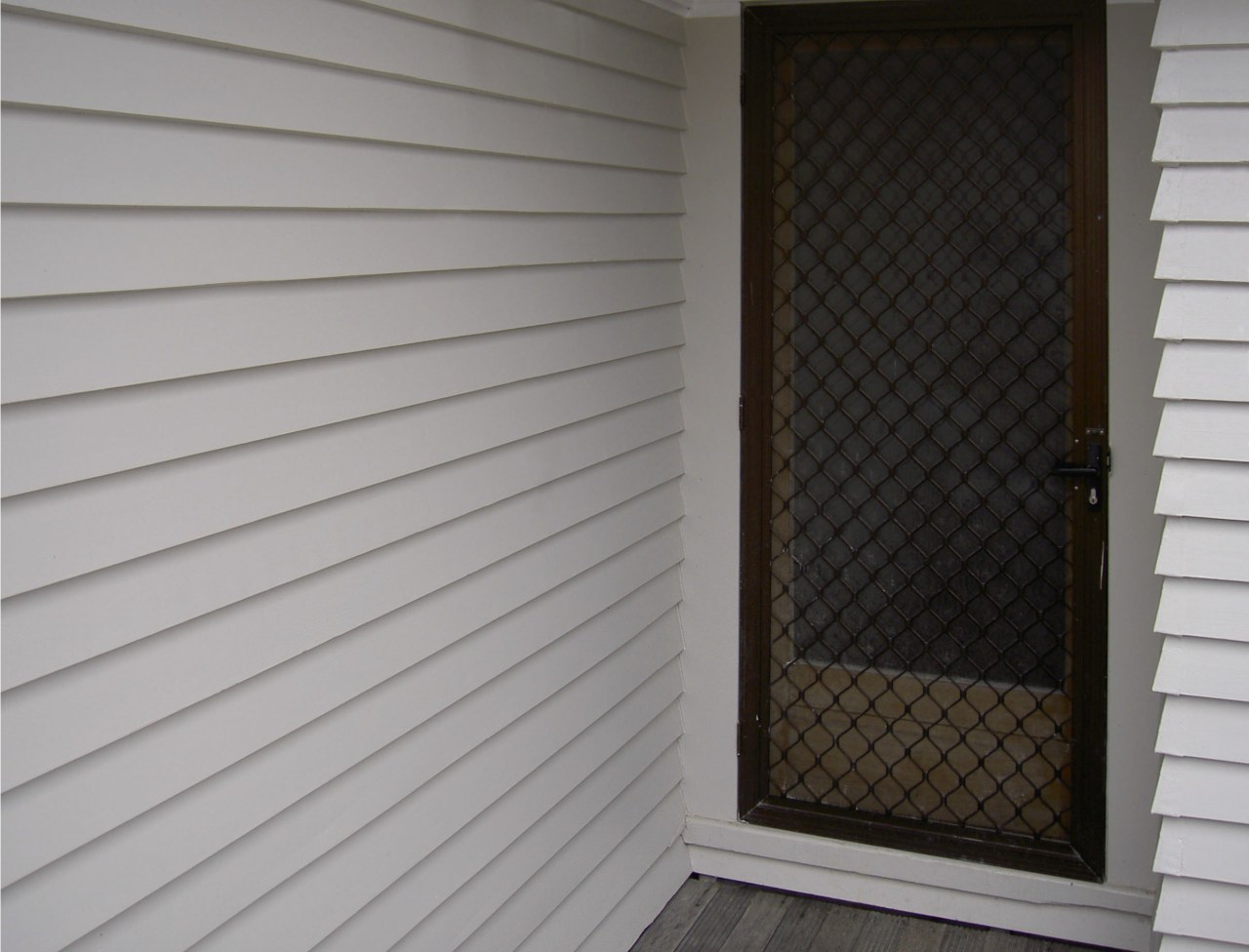 Qmulus BIB dry-fibre insulation being installed by an door, facade, floor, home, shade, siding, wall, window, window blind, window covering, window screen, window treatment, wood, wood stain, gray, black