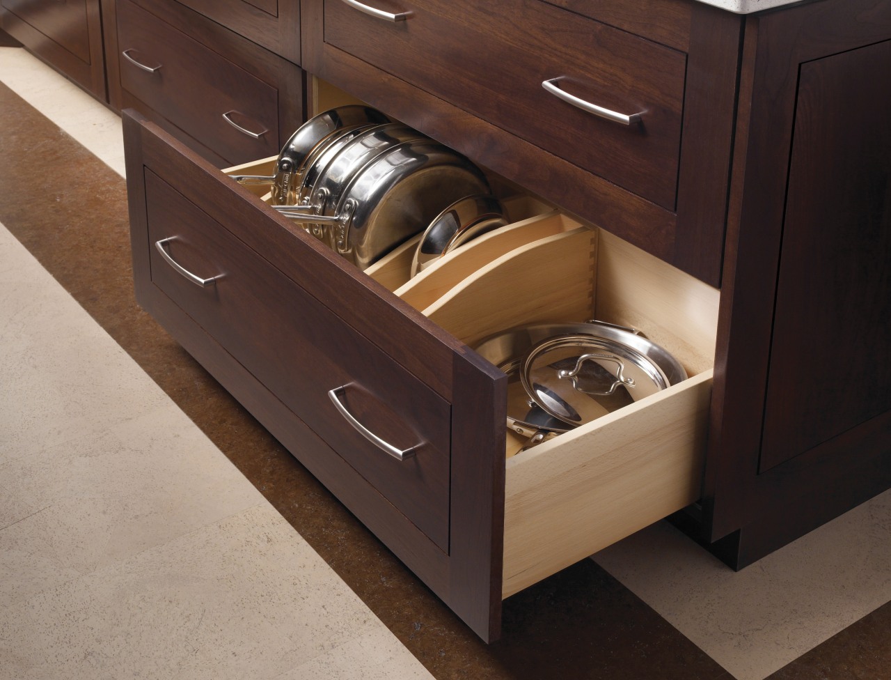 This kitchen features compartmentalized storage solutions.This kitchen features cabinetry, countertop, drawer, furniture, hardwood, kitchen, wood stain, red, brown