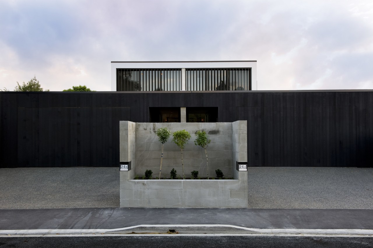 A concrete planter marks the beginning of an architecture, building, facade, home, house, luxury vehicle, property, real estate, residential area, black, white, gray