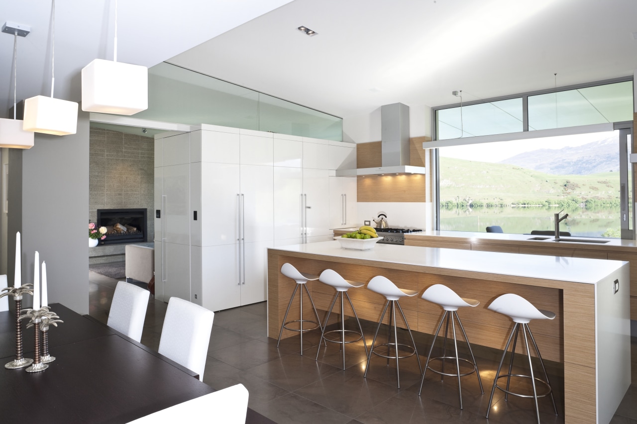 View of kitchen and living area featuring light architecture, countertop, interior design, kitchen, real estate, white