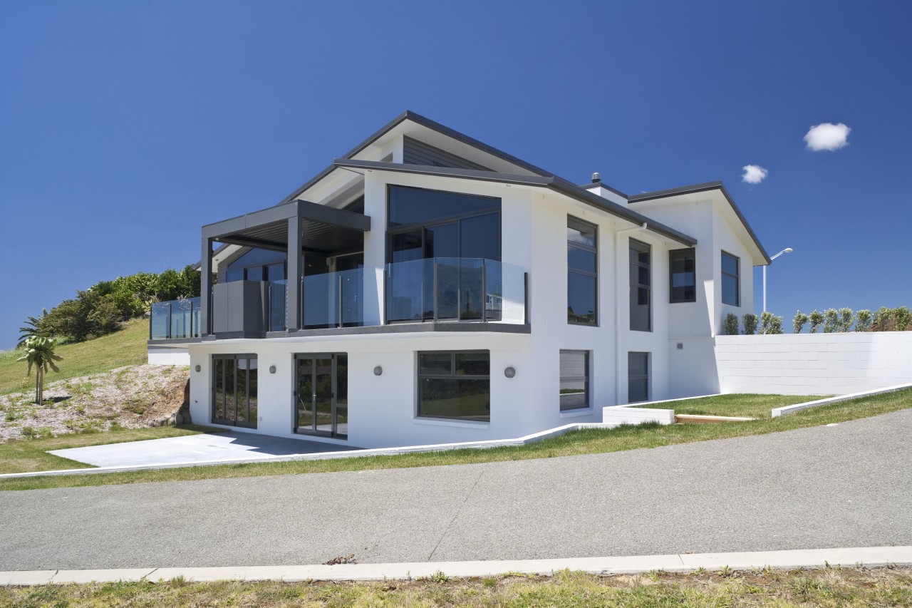 This home, by David Reid Homes Hauraki, features architecture, building, cottage, elevation, estate, facade, home, house, property, real estate, residential area, villa, blue, gray