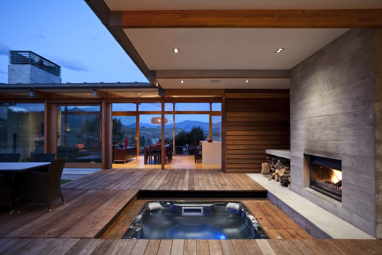 View of spa area with outdoor fireplace and architecture, estate, home, house, interior design, lighting, living room, real estate, swimming pool, window, wood, brown