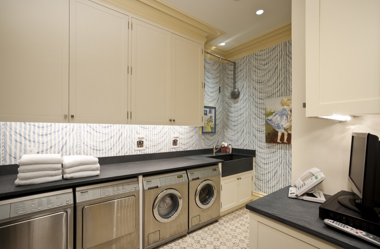 Interior view of this laundry area which features countertop, home, interior design, kitchen, laundry, laundry room, property, real estate, room, orange