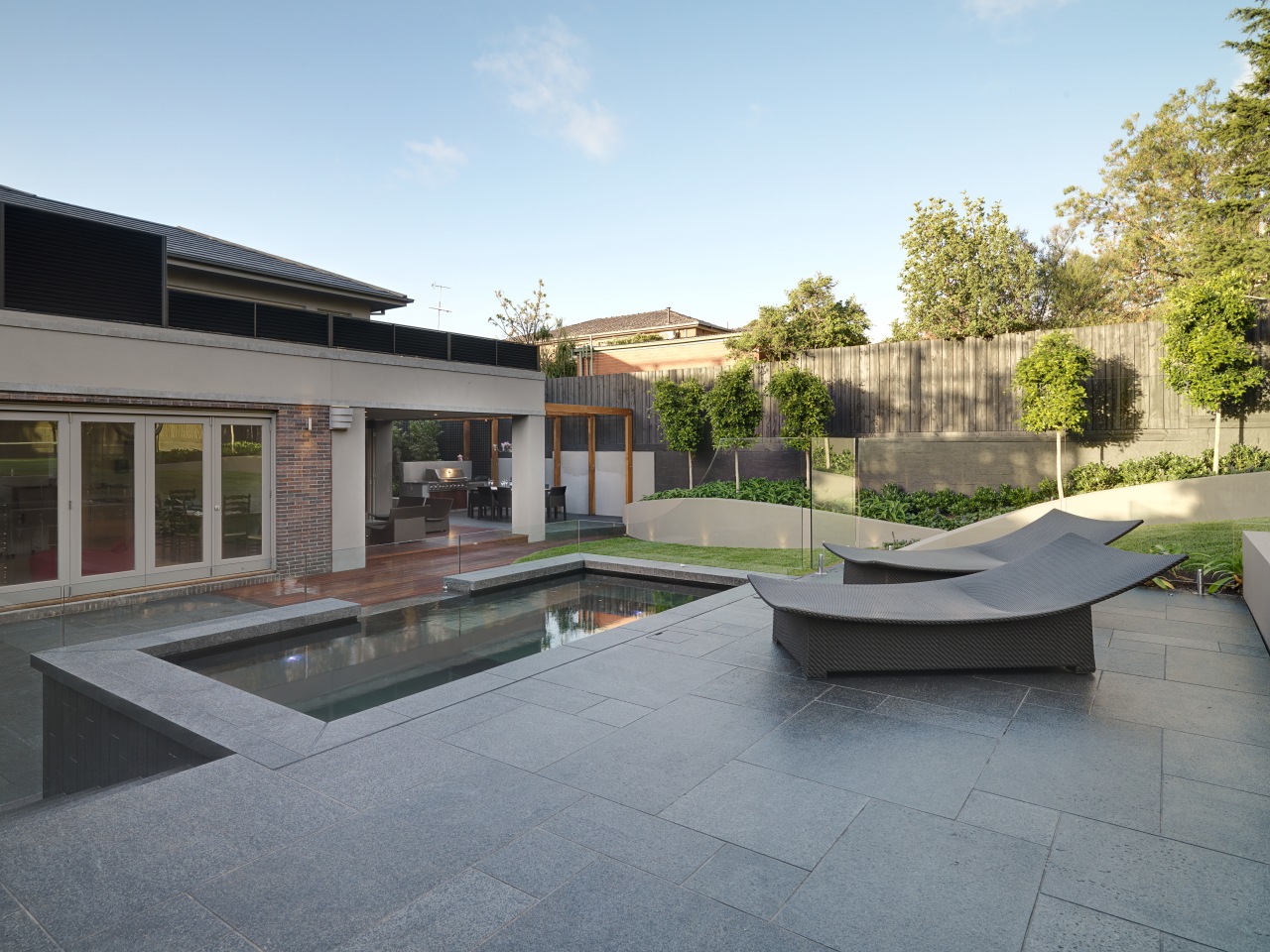 View of outdoor living space by Nathan Burkett apartment, architecture, backyard, condominium, courtyard, estate, home, house, property, real estate, residential area, swimming pool, villa, gray