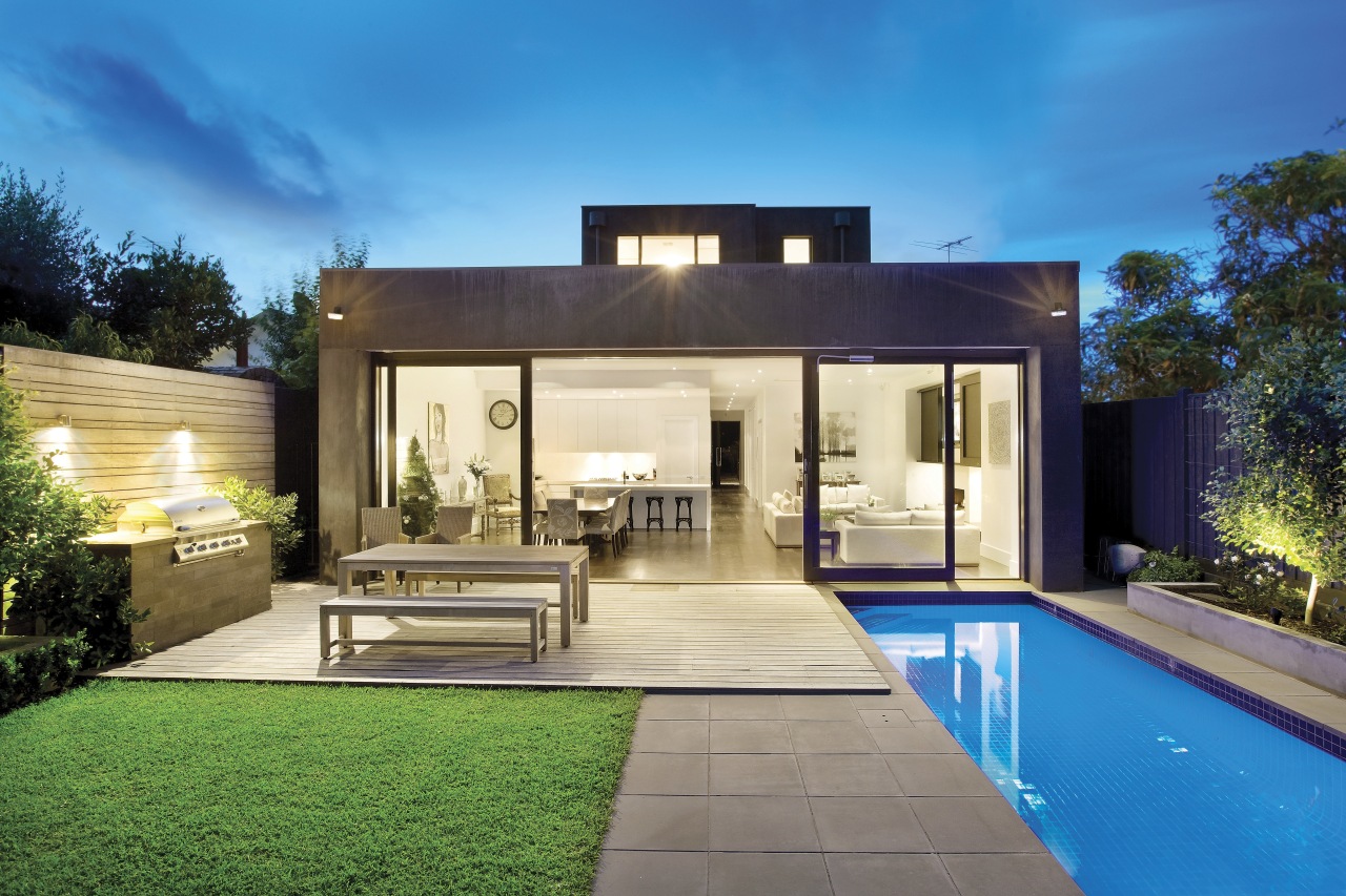 Exterior view of a flat-roofed home designed and architecture, backyard, elevation, estate, facade, family car, home, house, interior design, lighting, property, real estate, residential area, swimming pool, villa, yard, teal