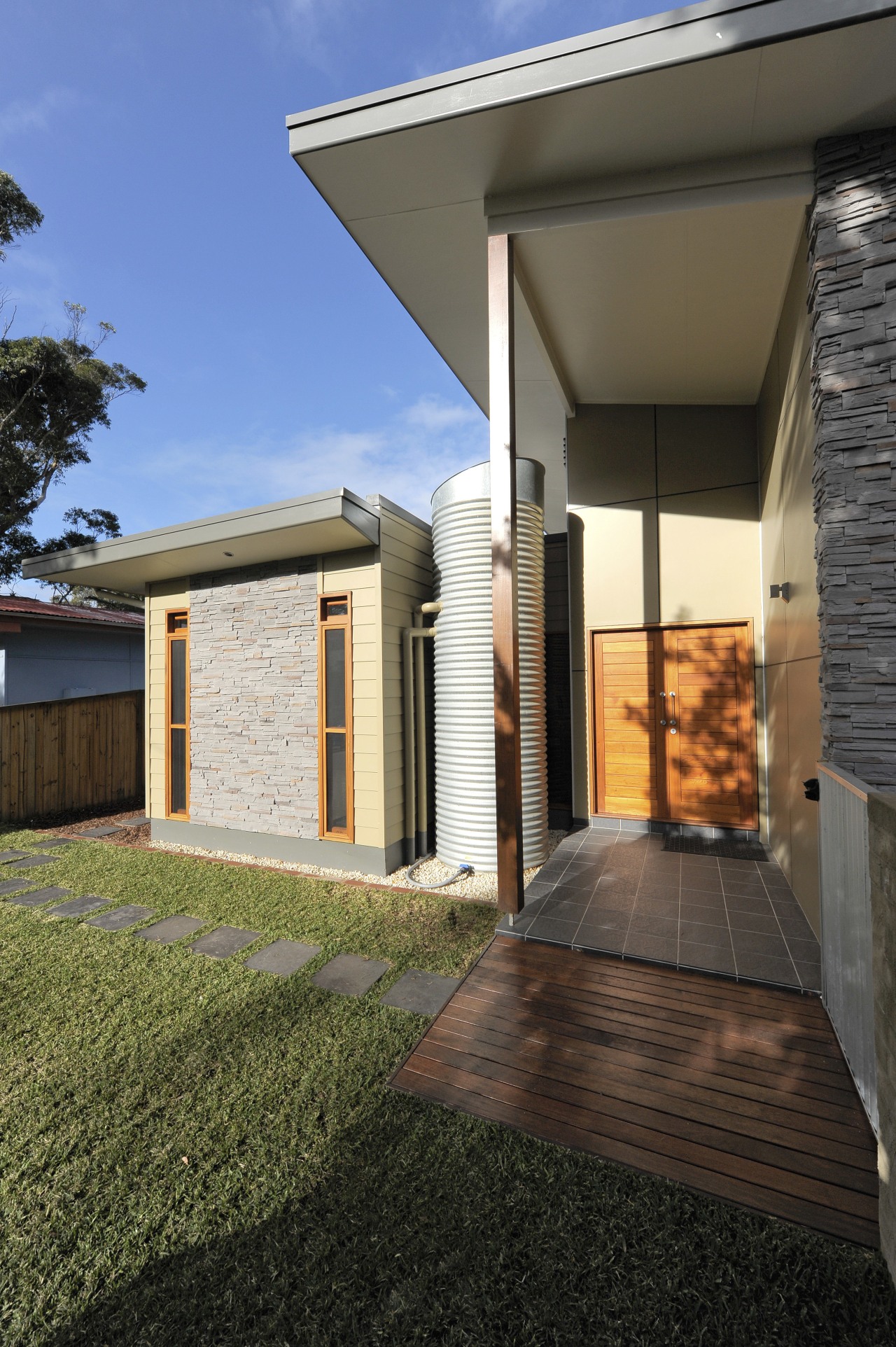 Exterior view of the entranceway which features a architecture, backyard, estate, facade, home, house, property, real estate, residential area, siding, villa, window, brown, black