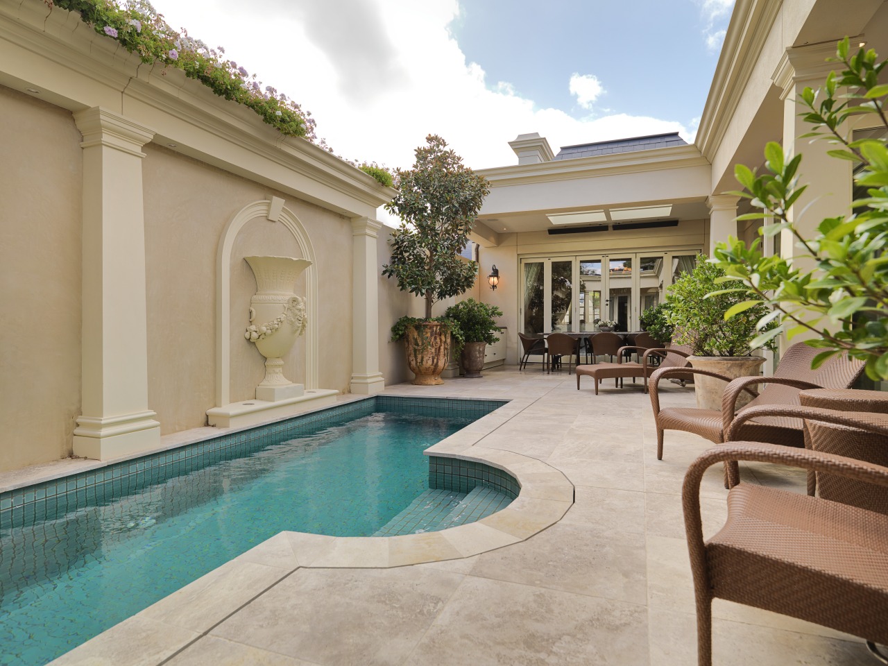 View of this pool and patio features outdoor apartment, estate, hacienda, home, house, leisure, property, real estate, resort, swimming pool, villa, gray, brown