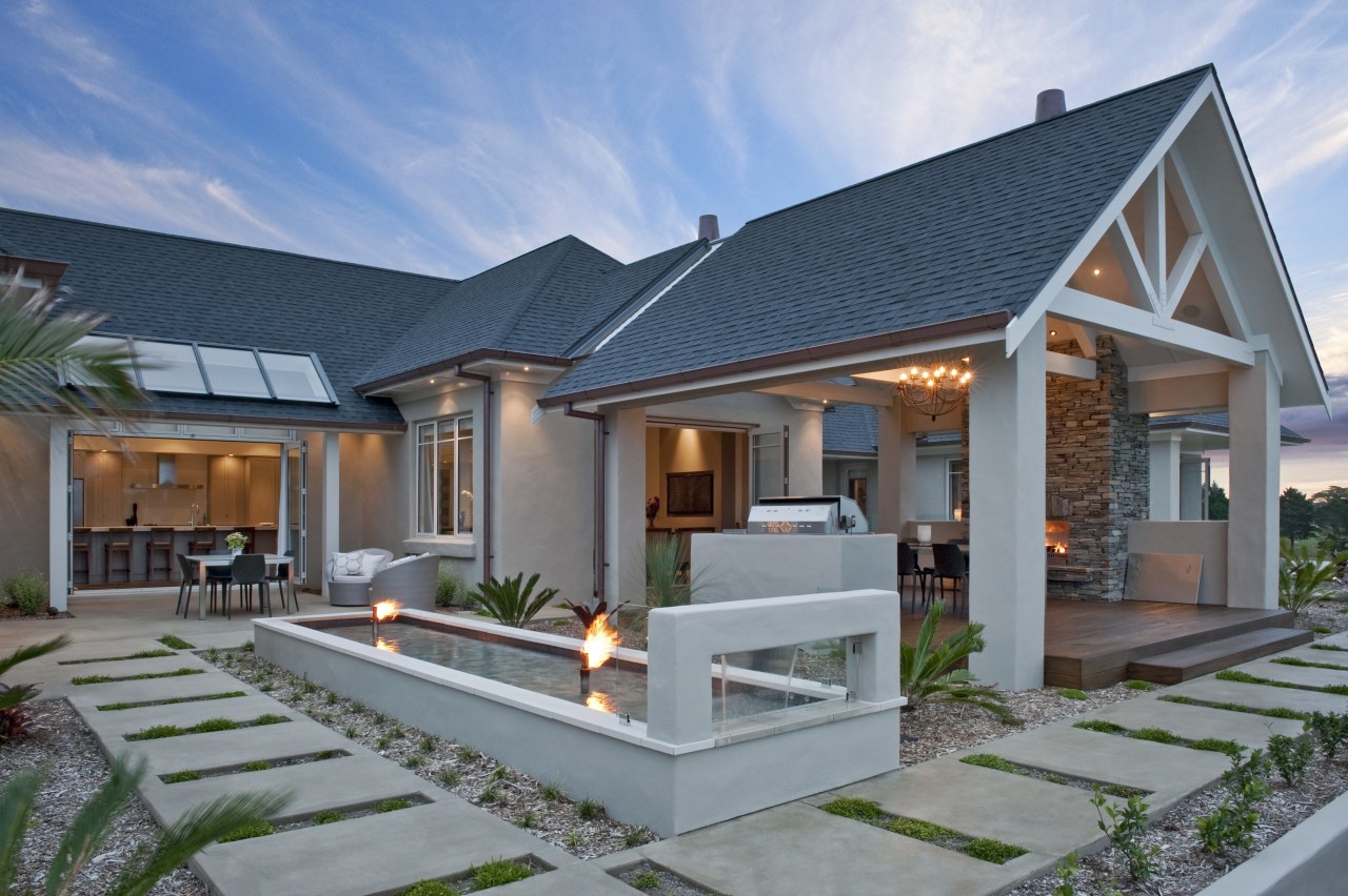 Exterior View of a masonry house built by cottage, elevation, estate, facade, home, house, property, real estate, residential area, roof, villa, gray