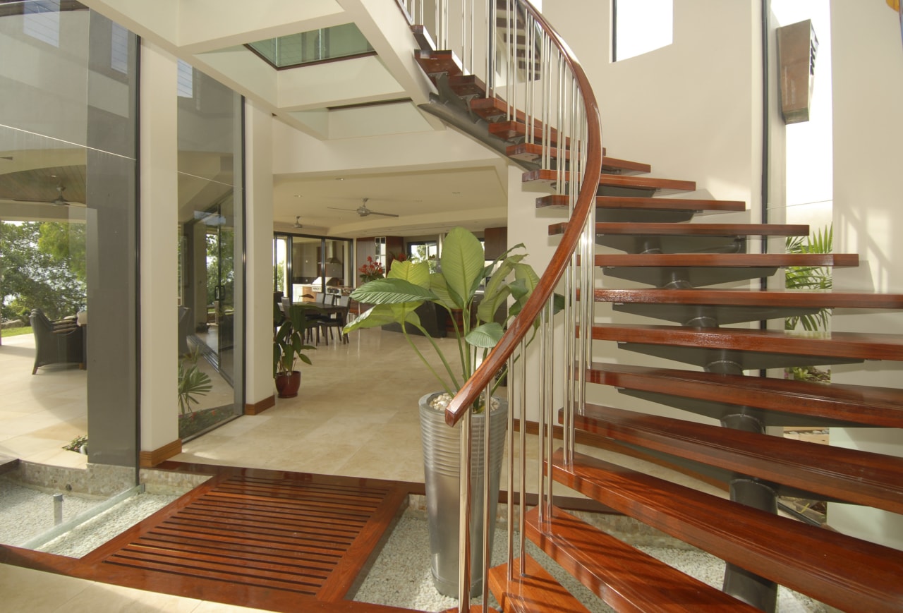 Interior view of a self sustainable house designed apartment, balcony, daylighting, estate, floor, flooring, handrail, hardwood, home, house, interior design, property, real estate, stairs, wood, brown, orange