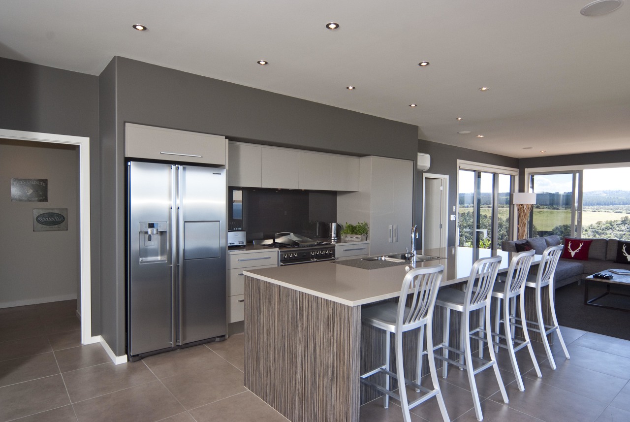 View of the kitchen area which features an countertop, floor, interior design, kitchen, property, real estate, gray