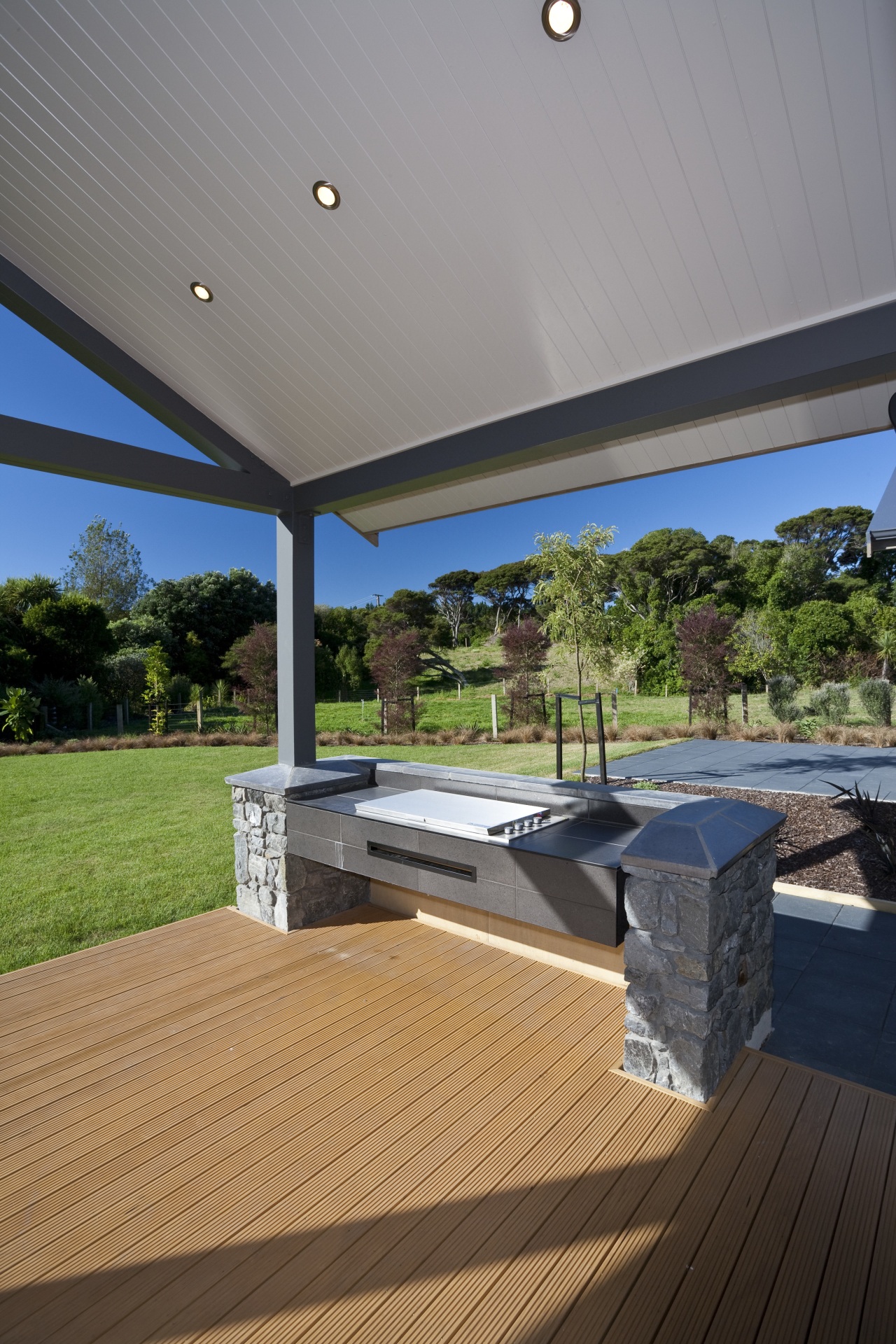 View of DRH show home outdoors kitchen which architecture, daylighting, deck, estate, floor, home, house, interior design, outdoor structure, porch, property, real estate, roof, wood, gray