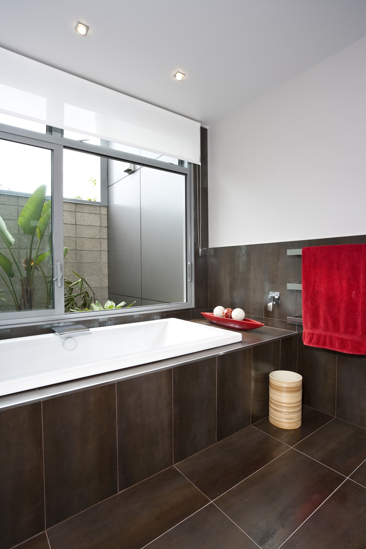 View of bathroom which features dark brown floor architecture, bathroom, countertop, interior design, real estate, room, window, gray, black