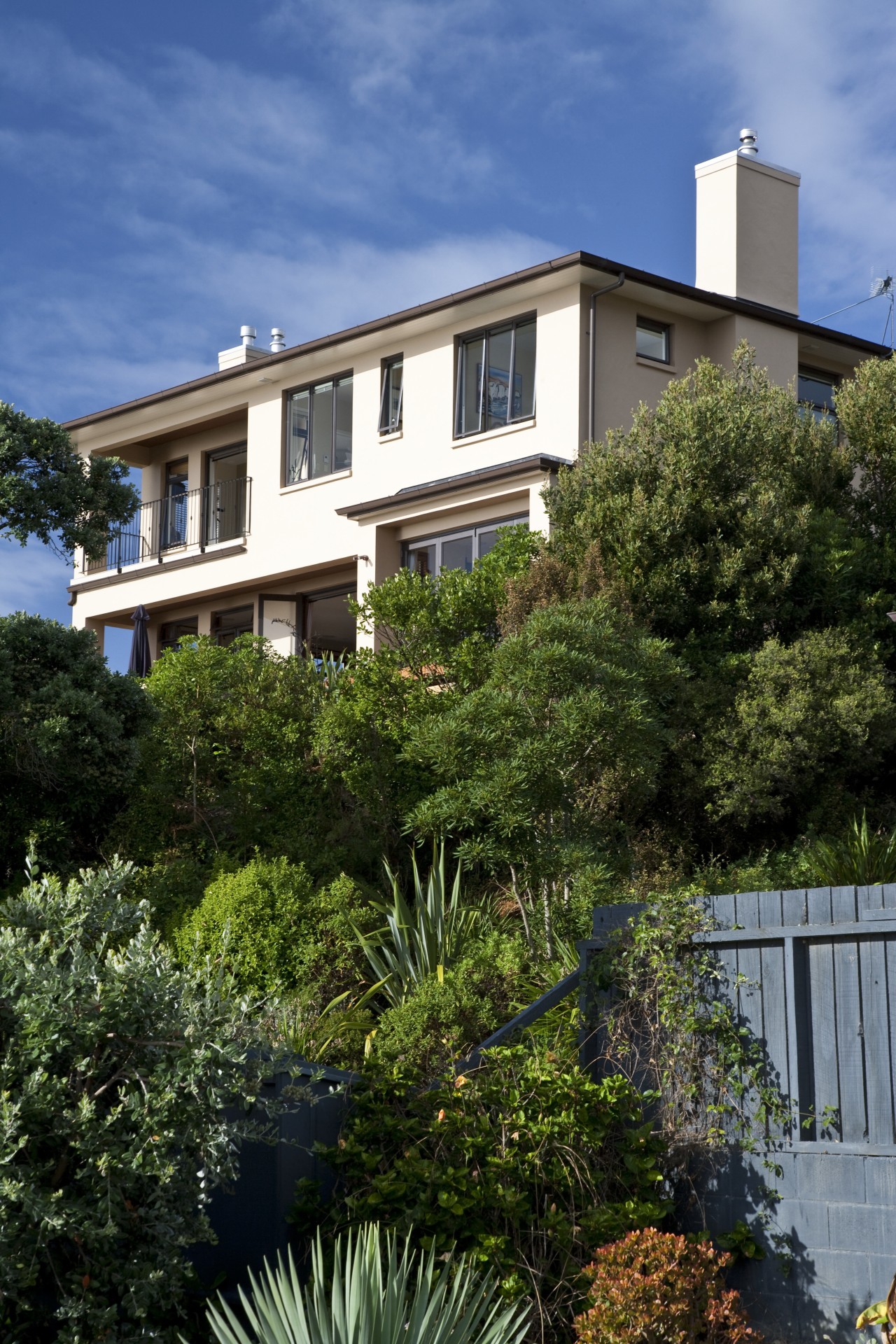 Exterior view of a home with Italian aesthetic apartment, architecture, building, cottage, estate, facade, home, house, landscaping, neighbourhood, outdoor structure, plant, property, real estate, residential area, roof, sky, suburb, tree, villa, window, brown